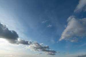 daytime sky with some oblong clouds