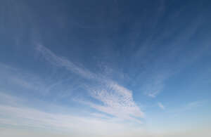 daytime sky with one thin cloud