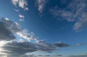 deep blue sky with greyish clouds