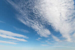 blue sky with a strip of white clouds