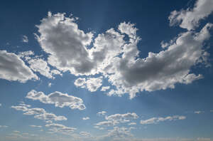 blue sky with backlit white clouds