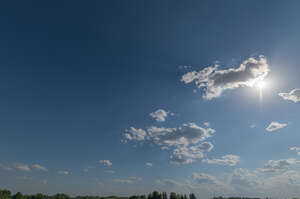 sky with few small clouds and a sun