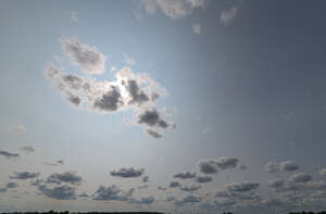 sky with some sun visible behind a small cloud