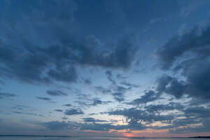 blue late night sky with sun setting