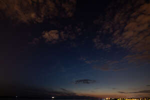 night sky with some clouds and city lights