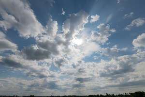 cloudy daytime sky with sun partly visible