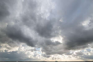 sky with grey clouds and sun rays