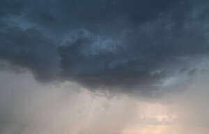 sky with a dark cloud and some light rays