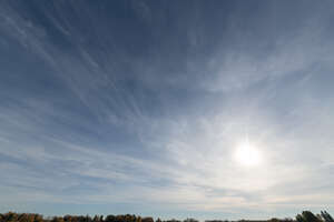 daytime sky with sub and thin clouds