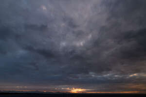 dramatic sunset with very dark clouds