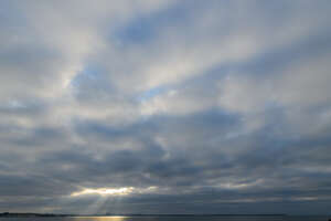 cloudy sky with rays of sunshine