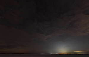 northern night sky with bright stars and little clouds