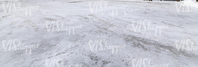 paved field with thin layer of snow