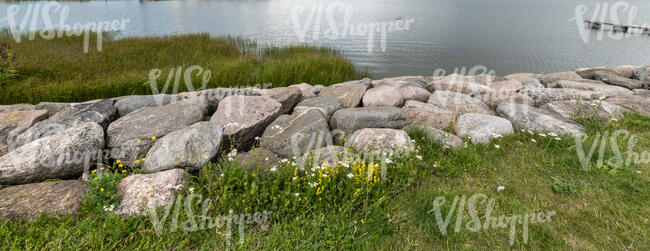 large rocks on the grassy shore