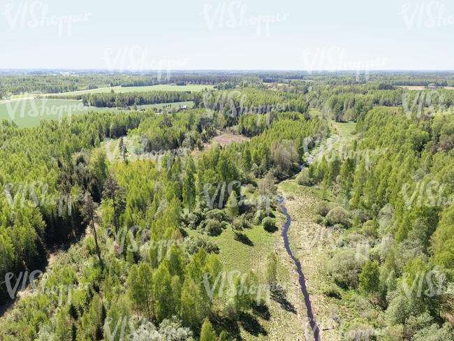 aerial view of a landscape with forests and river in spring