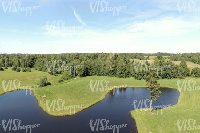 bird-eye view of a landscape with lake and grassland