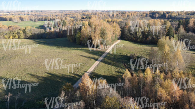 bird eye view of a motorway through natural landscape  in the autumn