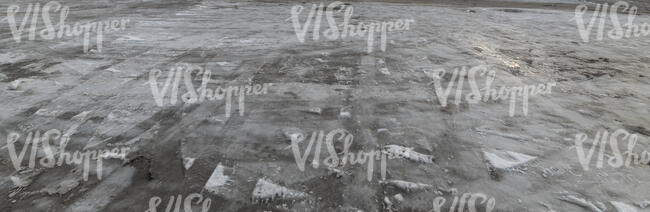 field of asphalt covered with melted ice and snow