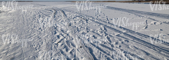 white snow with tyre tracks and footprints