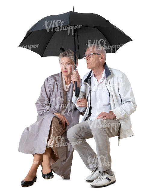 cut out elderly couple sitting together under an umbrella