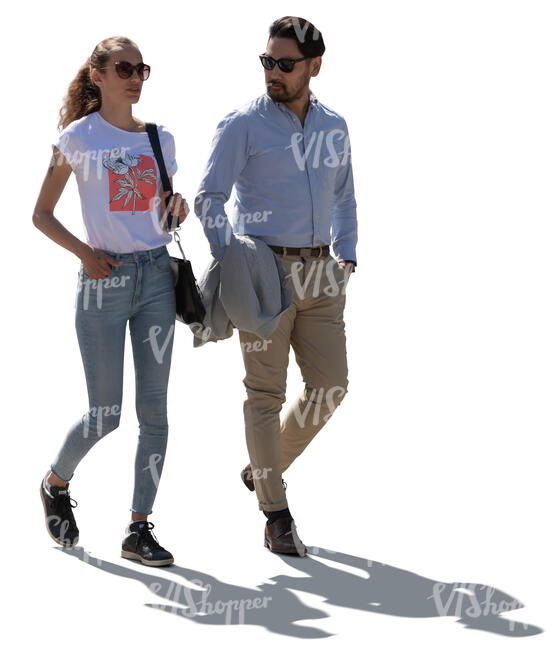 backlit man and woman walking