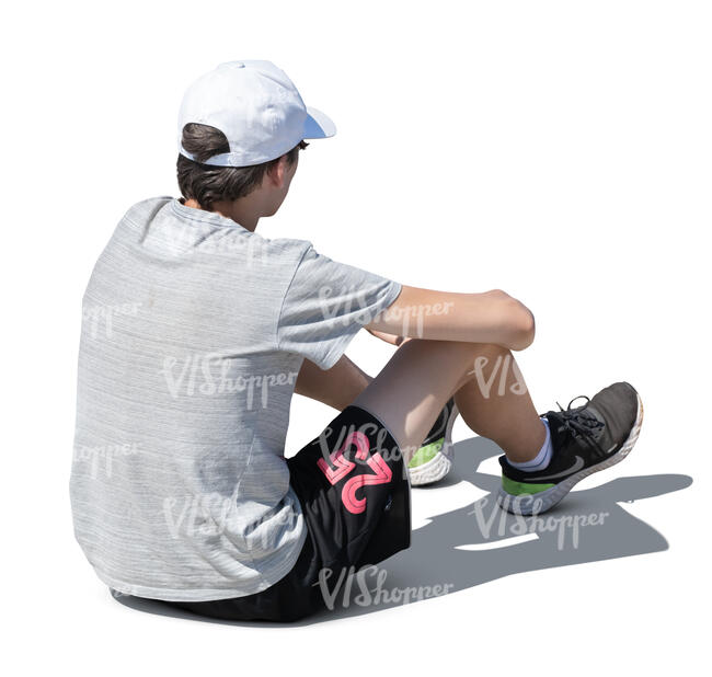 cut out teenage boy sitting on the ground