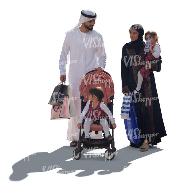 backlit arab family with shopping bags walking