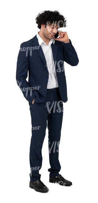 cut out dark haired man in a suit standing and talking on a phone