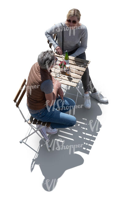 top view of a backlit couple sitting in a cafe