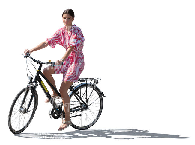 backlit woman in summer riding a bike