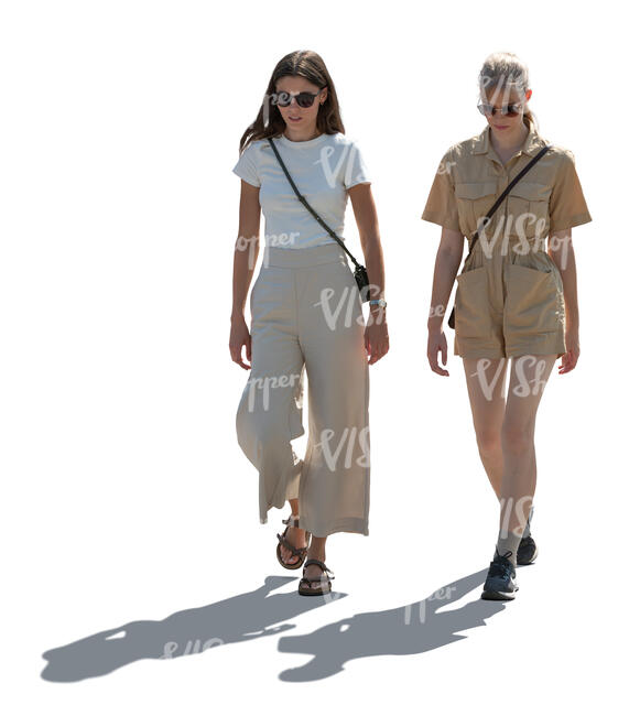 two cut out backlit women walking