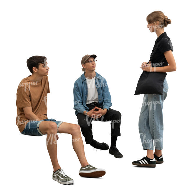 woman standing and talking to two men sitting