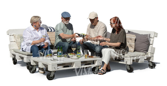 group of senior friends sitting having a garden party