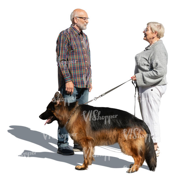 two elderly people with a dog standing