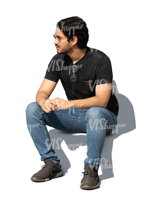 dark haired man sitting outside