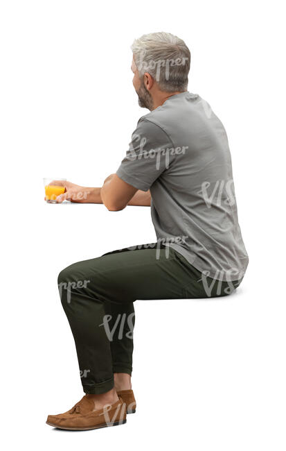 man sitting and drinking orange juice