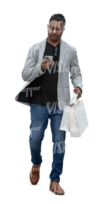 indian man with shopping bags and a phone walking