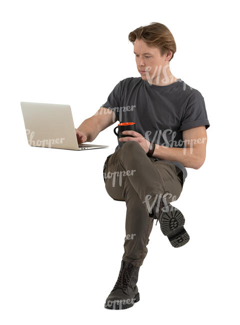 man sitting and drinking coffee and working with a computer