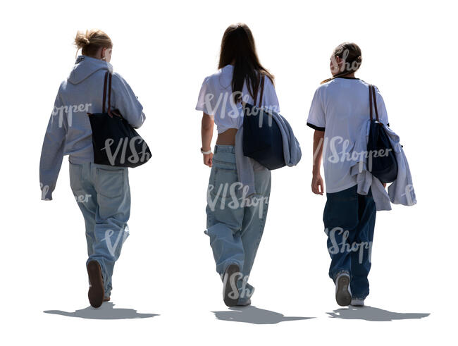 backlit group of three young women walking