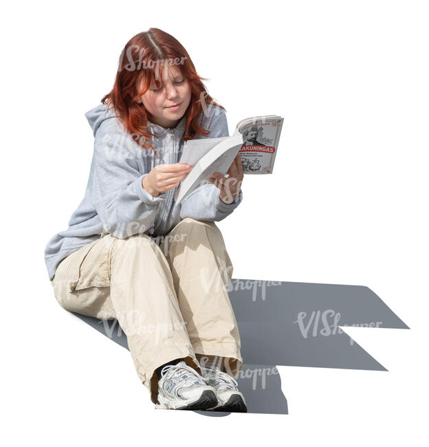 teenage girl sitting and reading a book