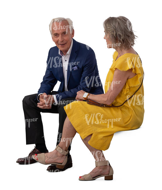 older man and woman at a formal event sitting and talking