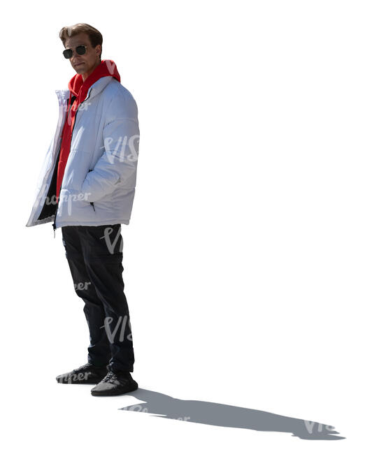 backlit young man wearing a white bomber jacket standing