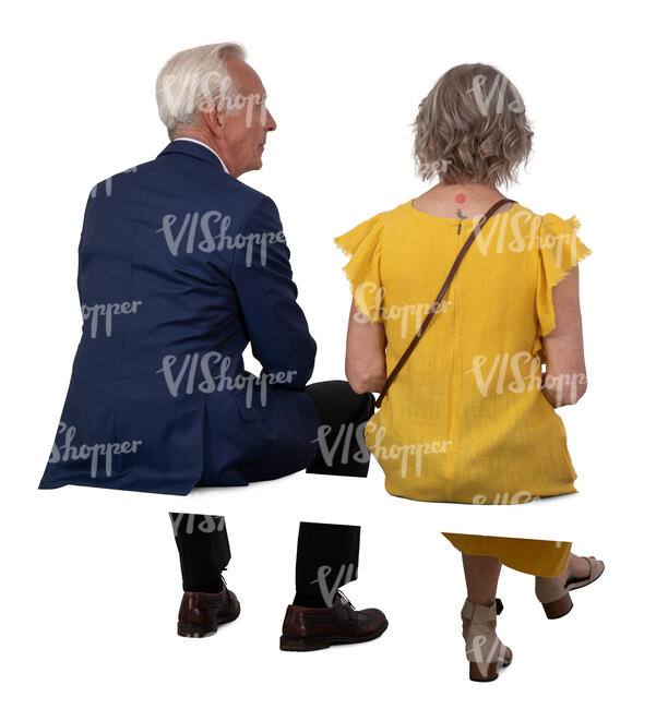 two older people sitting at a formal event
