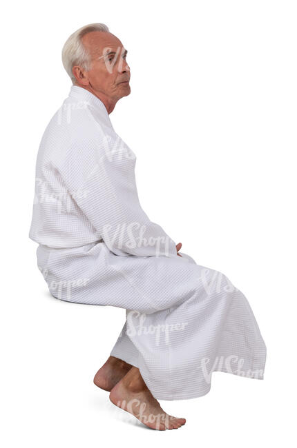 cut out older man in a white spa bathrobe sitting