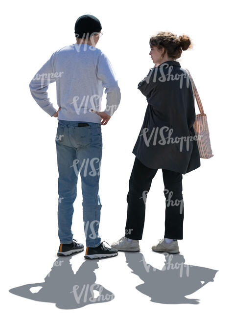 two backlit people standing