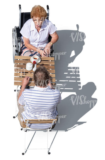 top view of two older people sitting in a cafe