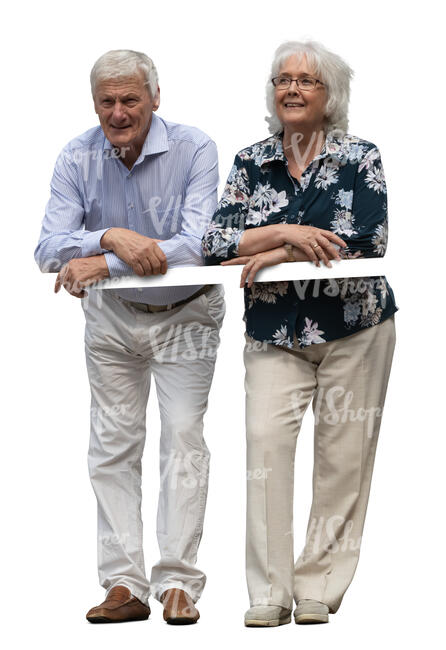 two senior people standing on a balcony and leaning on a railing