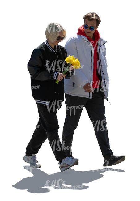 cut out backlit man and woman walking and holding flowers