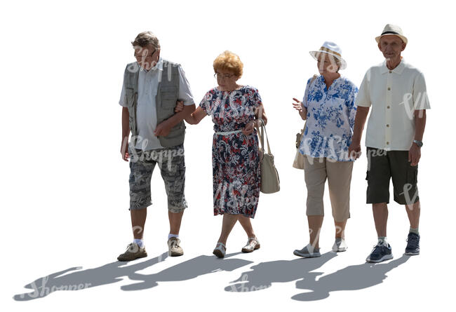 two backlit elderly couples walking