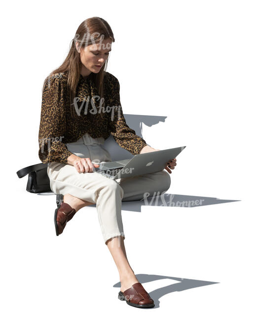 young woman sitting outside and working with laptop